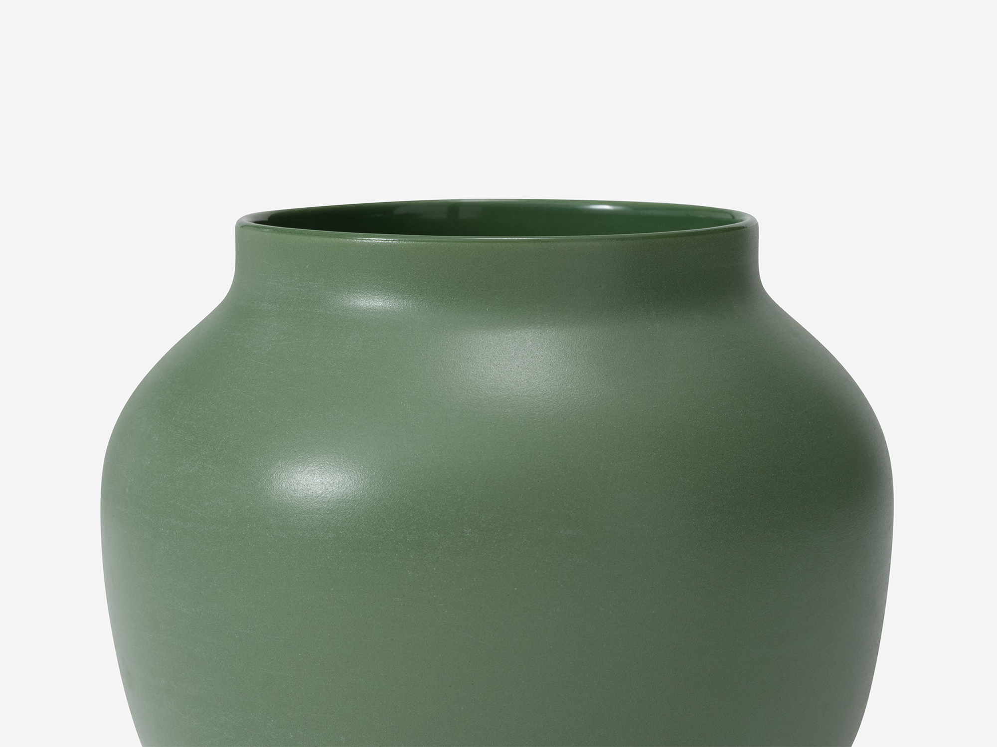 Detail view of small green ceramic vase